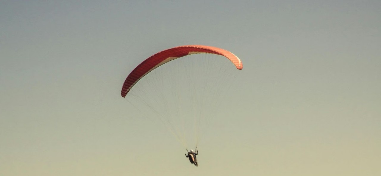 Student's Sky-High Solution: Paraglides to Exam Center in Record Time